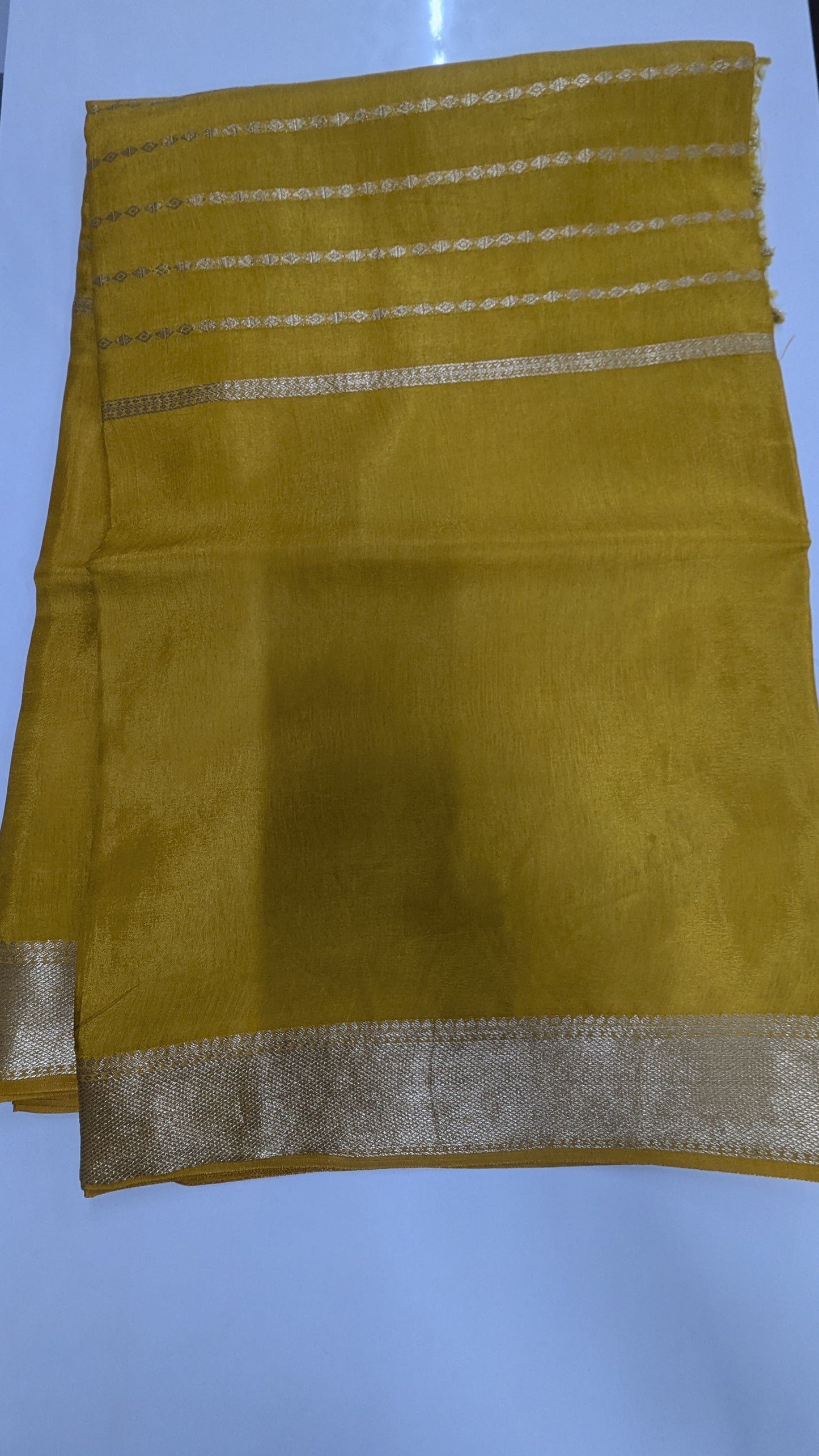 Mustard color Semi Crepe Silk Saree with Center Zari Lines and Border